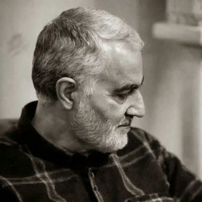 Grayscale photo: Bearded man with salt-and-pepper hair in profile.