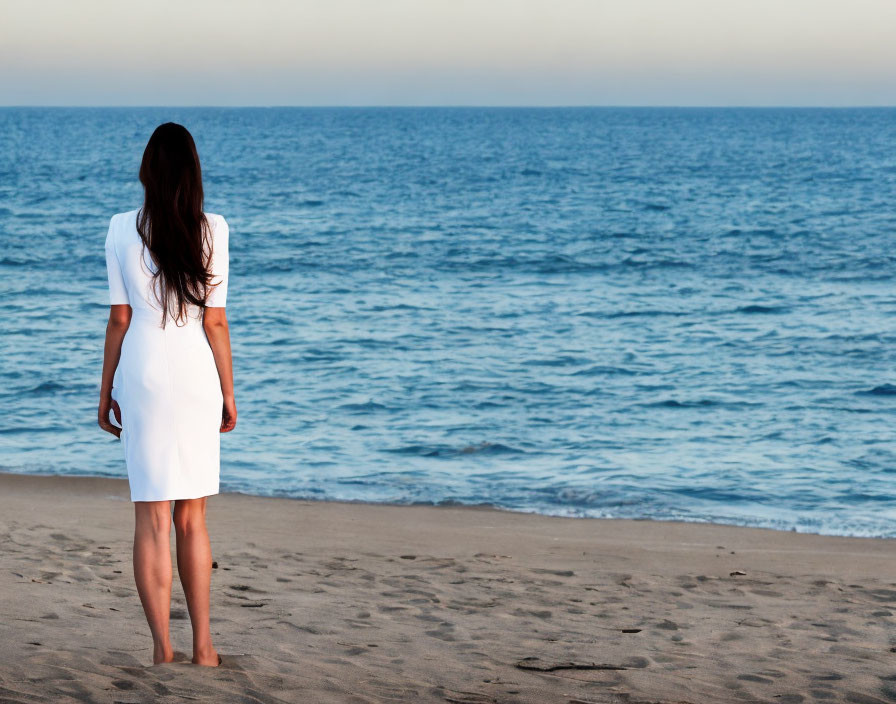 Woman in White Dress on Beach at Early Evening