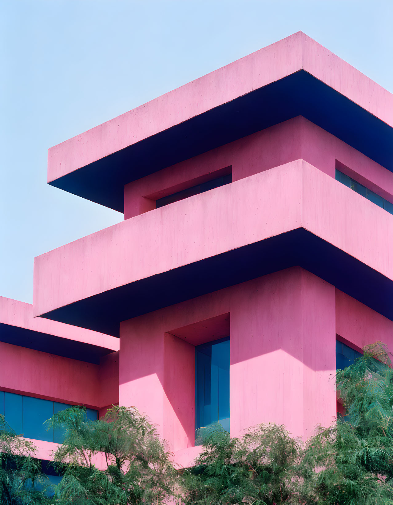 Pink brutalism concrete building and wild plants