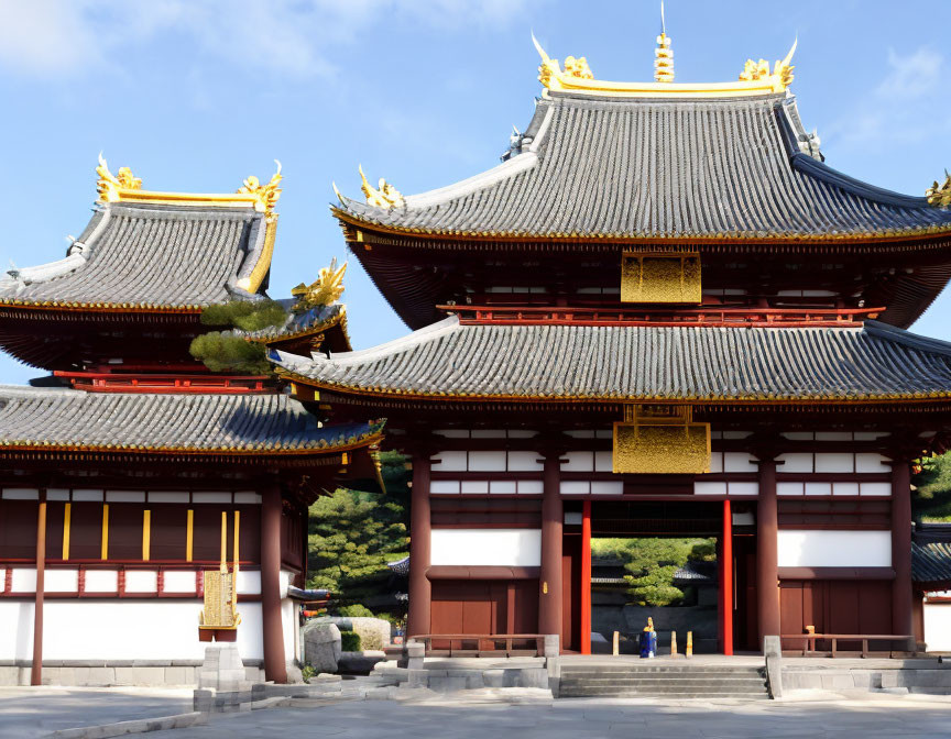 Traditional Japanese Temple with Golden Accents in Clear Sky