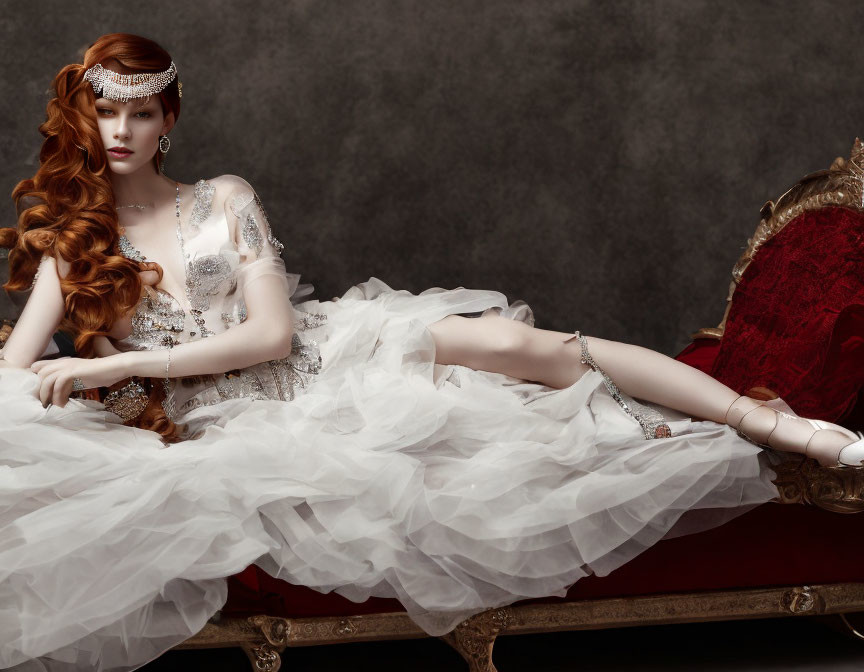 Red-haired woman in white dress on red chaise lounge exudes vintage luxury