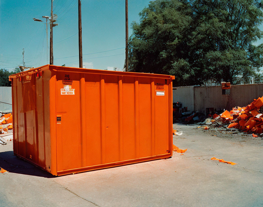 Orange Dumpster with debris
