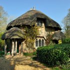 Thatched Roof Cottage Surrounded by Gardens and Moon