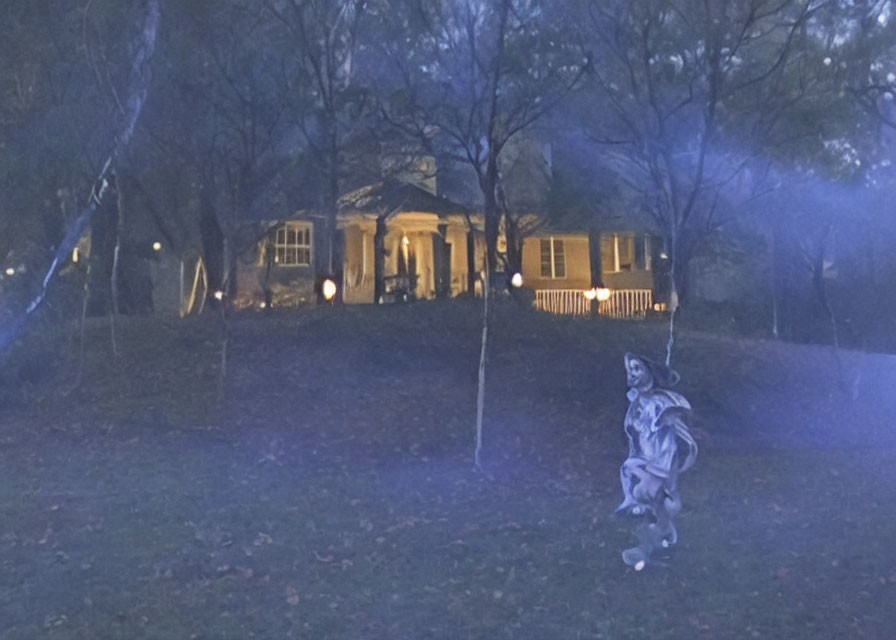 Dimly lit house with ghostly figure in spooky night scene