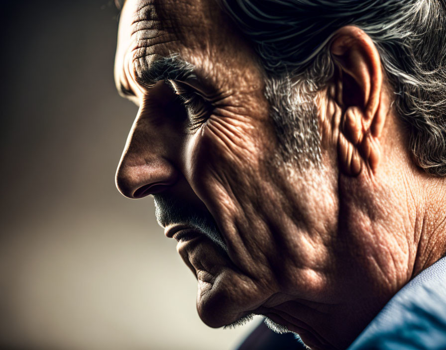 Elderly man with deep wrinkles and prominent nose in contemplative pose