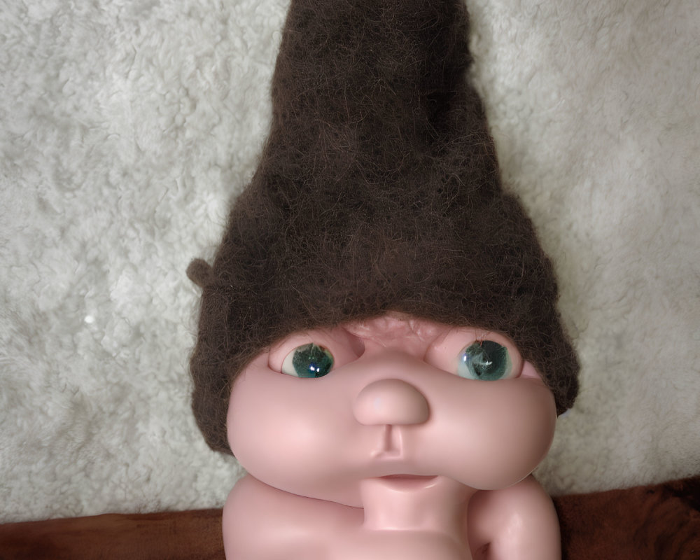 Exaggerated features doll with pointy hairdo and green eyes on white and brown background
