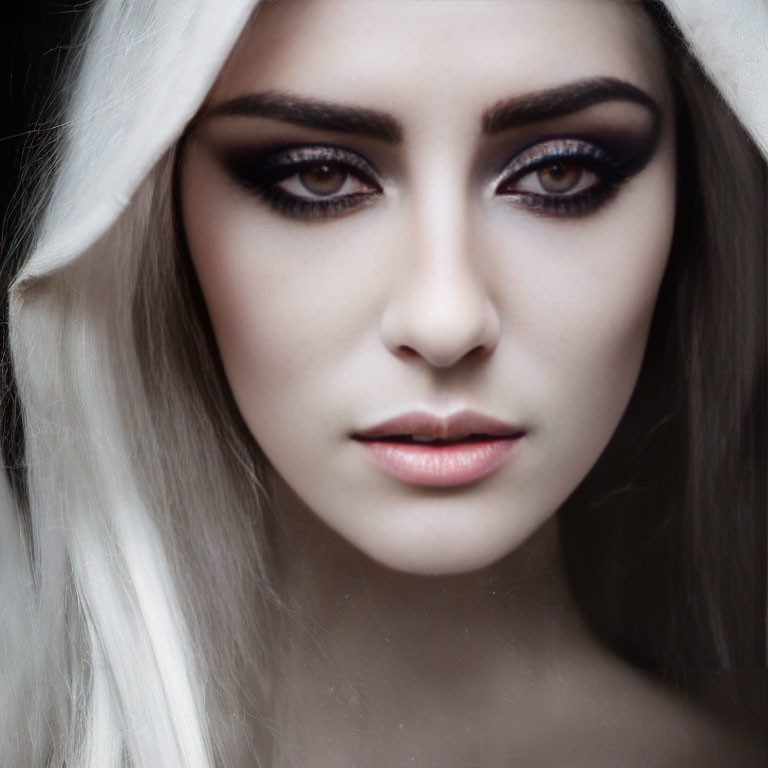 Intense smoky eye makeup on woman with pale skin and white head covering