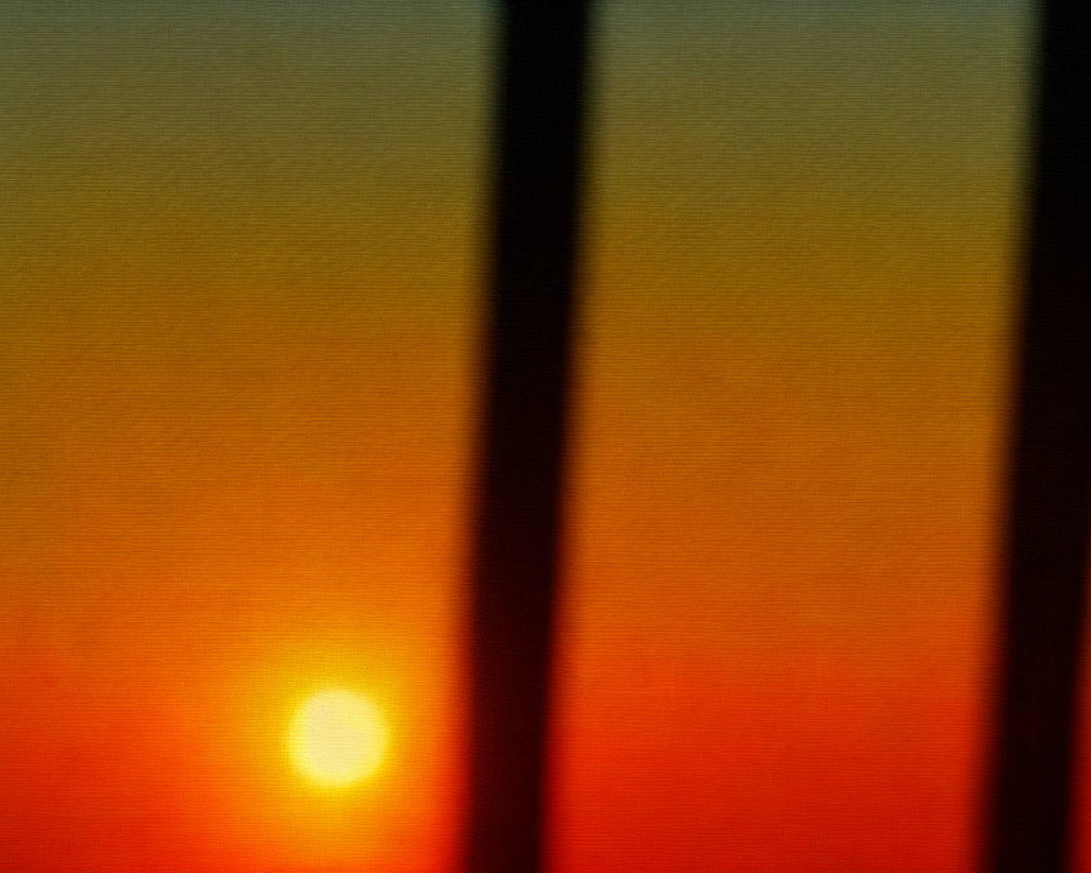 Scenic sunset view through window blinds on orange sky