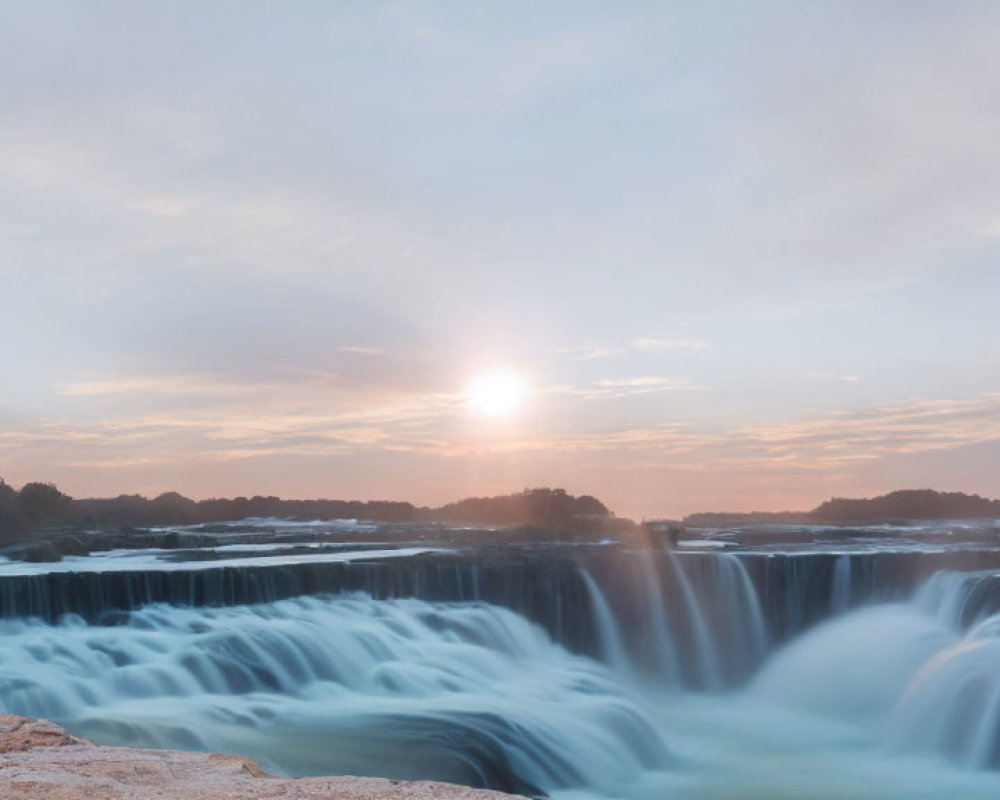 Scenic sunrise view of cascading waterfall and smooth water flow