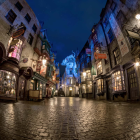 Eerie cobblestone street with crooked houses at twilight