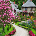 Scenic village pathway with tulips, cottages, and flower-filled window boxes