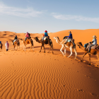 Colorful Camel Caravan Passing Desert Campsite with Tents