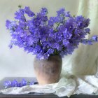 Colorful painting: Purple flower bouquet in reflective vase on white cloth