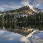 Serene landscape: reflective lake, autumn trees, misty mountains
