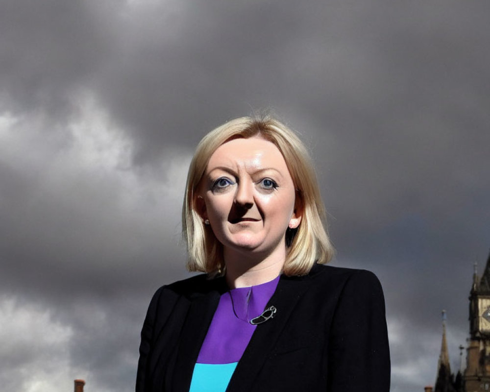 Blonde woman in professional attire under cloudy sky with architectural structures