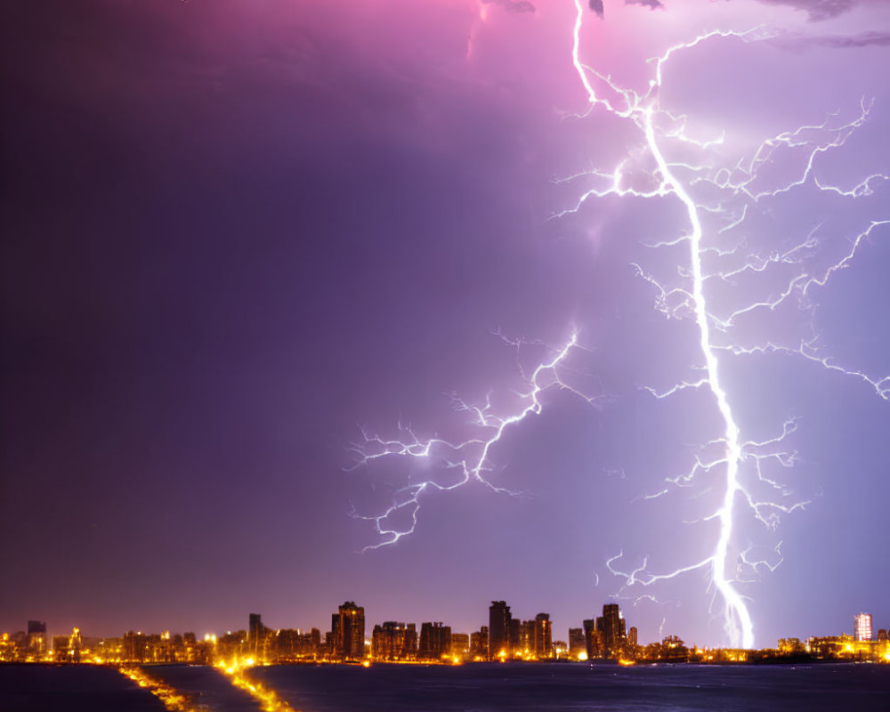 Vibrant lightning bolt illuminates cityscape at night