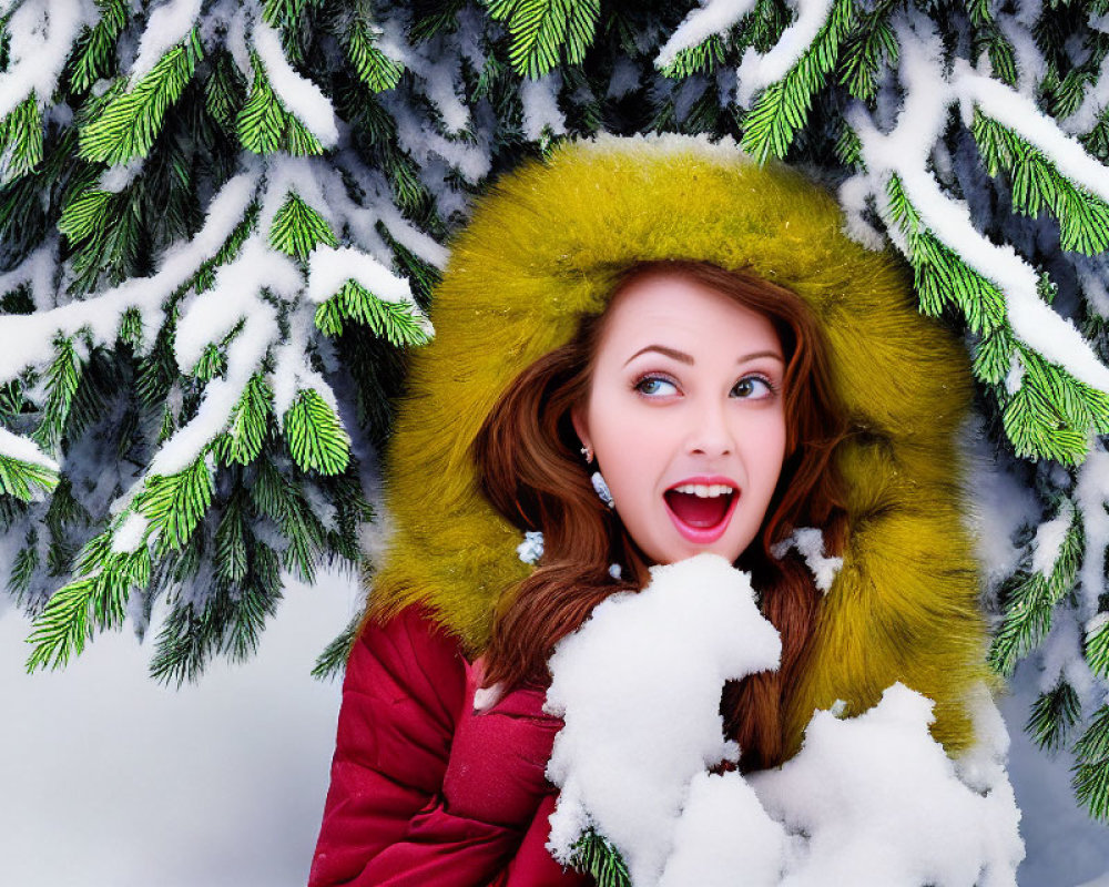 Smiling woman in green furry hood in snowy pine forest