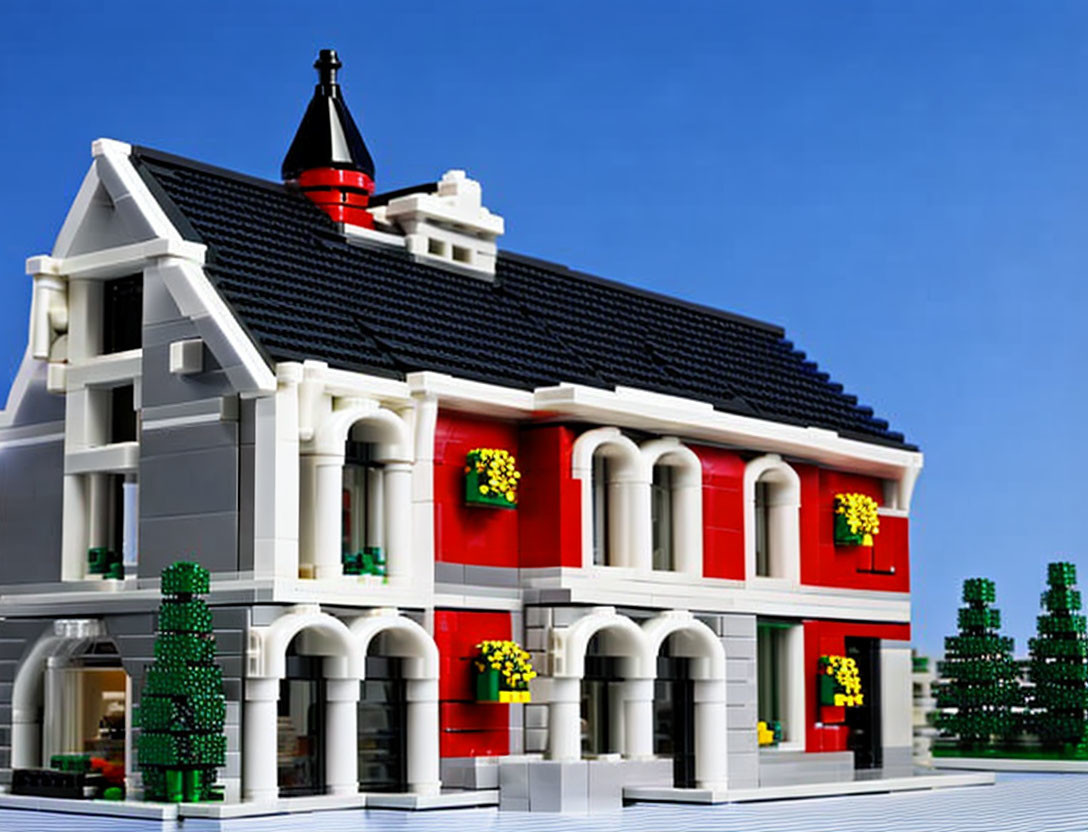 Detailed LEGO model of two-story building with red and white facade, black roof, green shutters,