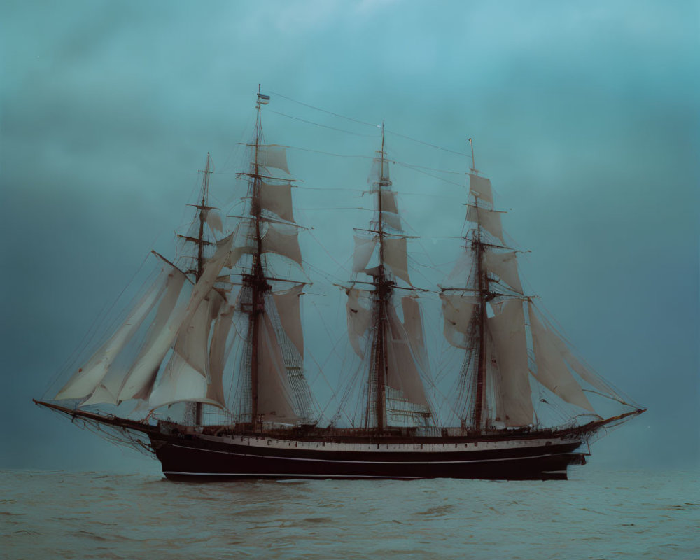 Tall ship with multiple masts sailing on calm sea under overcast sky