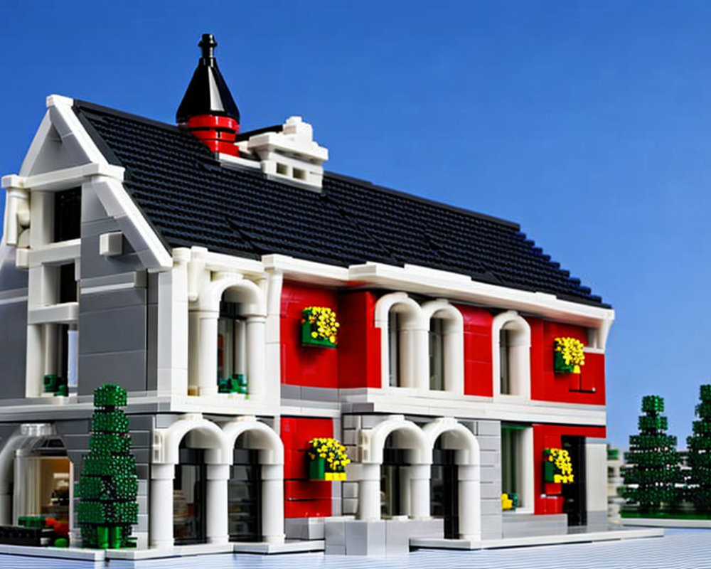 Detailed LEGO model of two-story building with red and white facade, black roof, green shutters,