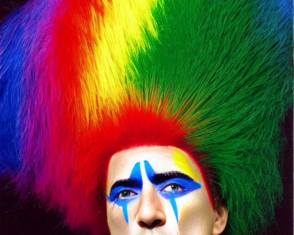 Vibrant rainbow mohawk and blue face paint portrait