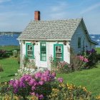 White Cottage with Red Chimney Surrounded by Wildflowers in Vibrant Painting