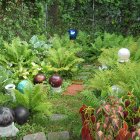 Colorful garden painting with lush greenery, flowers, orbs, and stone path.
