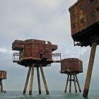 Abandoned sea forts with multiple legs under cloudy sky