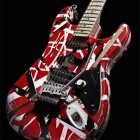 Vibrant guitar image with colorful paint splash on black background