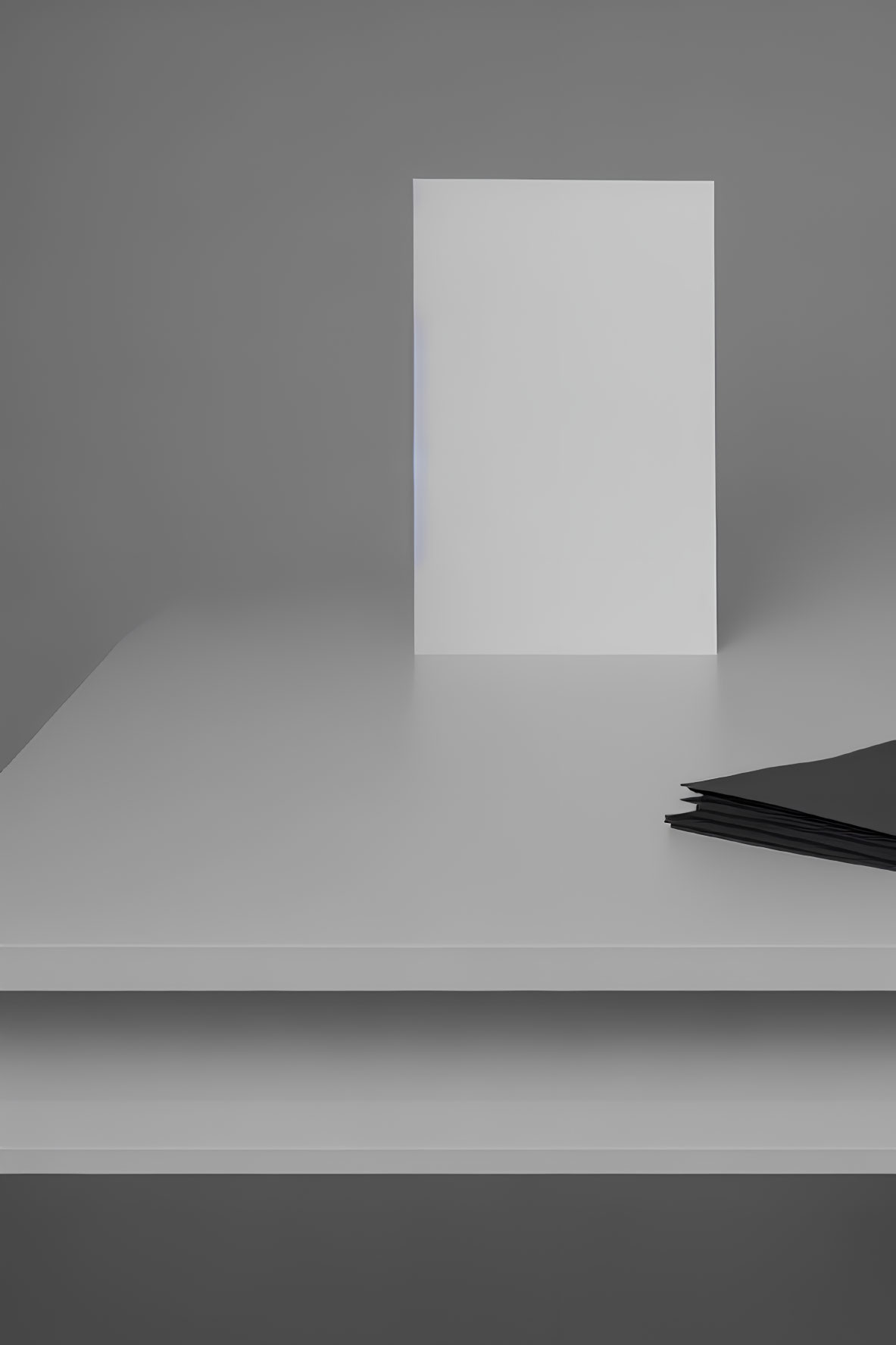 White canvas on grey tabletop with black sheets, grey background