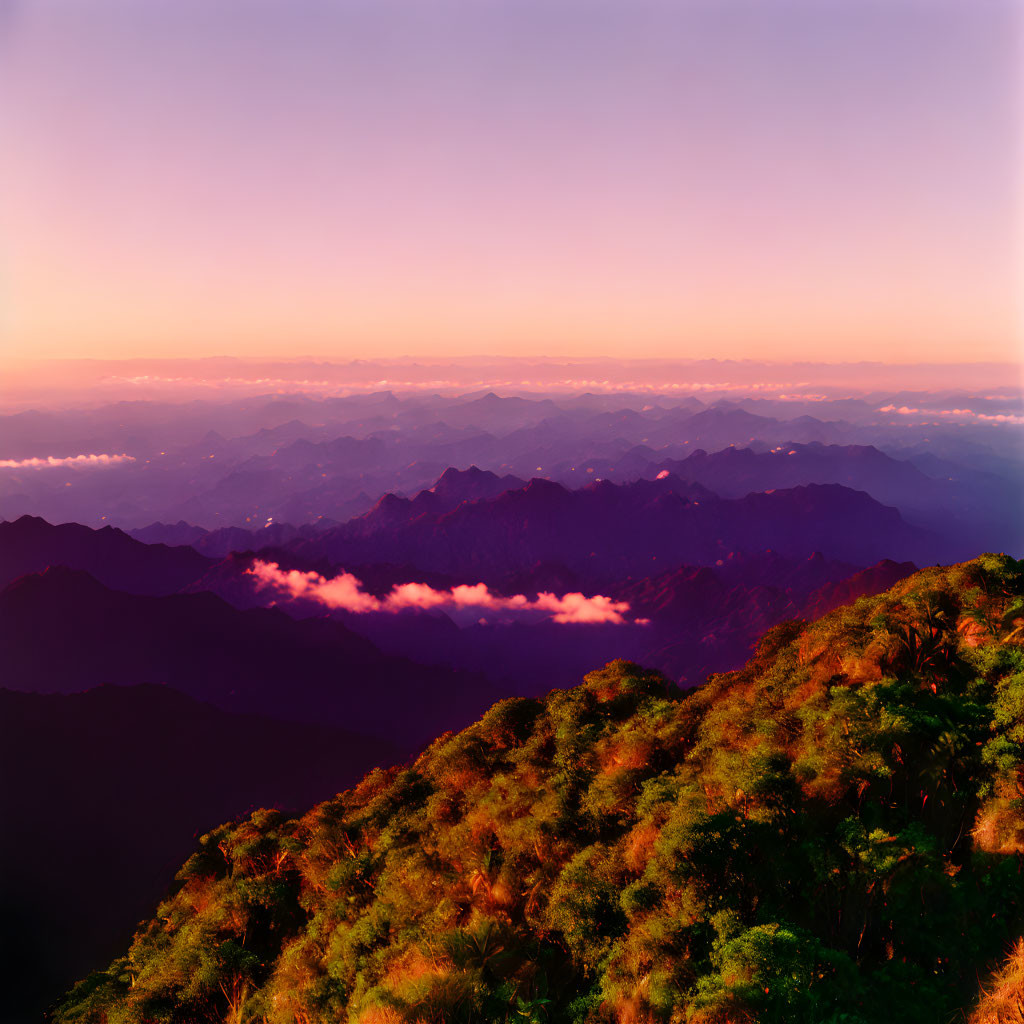 Scenic mountain landscape at sunrise with lush greenery and clouds