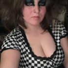 Woman with Wavy Hair in Checkered Dress and Sunglasses