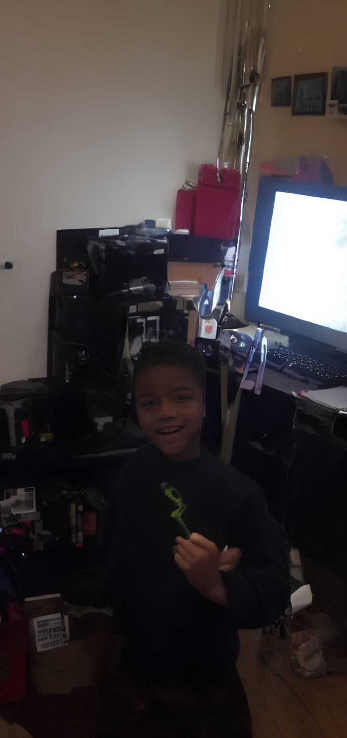 Young boy smiling in room with electronic equipment
