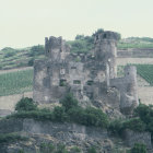 Watercolor landscape of medieval castles on green hills under overcast sky