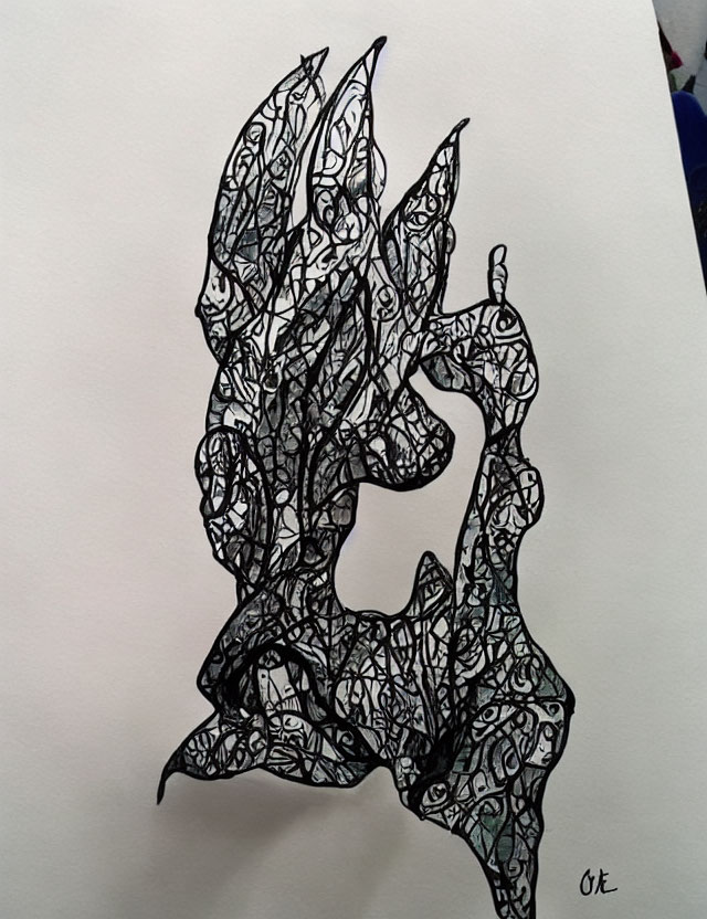 Abstract black ink doodle with leaf and flame patterns on white paper - artist signed