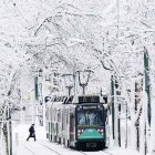 Vintage tram in snowy landscape with pagoda and bare trees