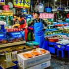 Colorful Street Market with Fresh Produce and Chef Cooking