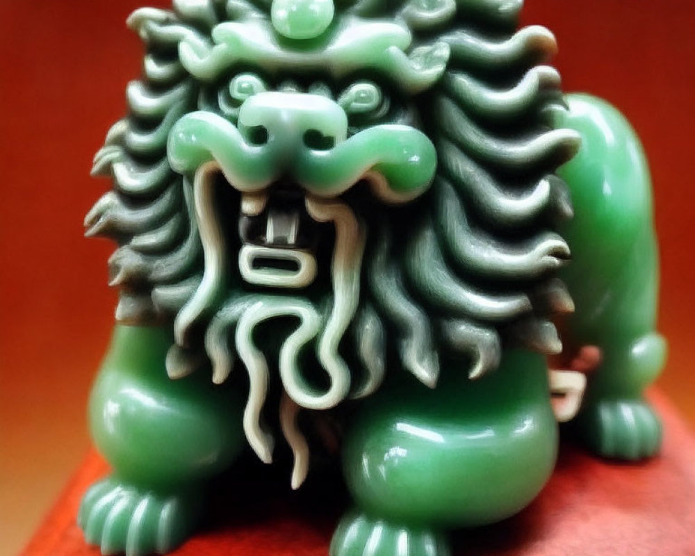 Mythical lion jade figurine with detailed mane on wooden base