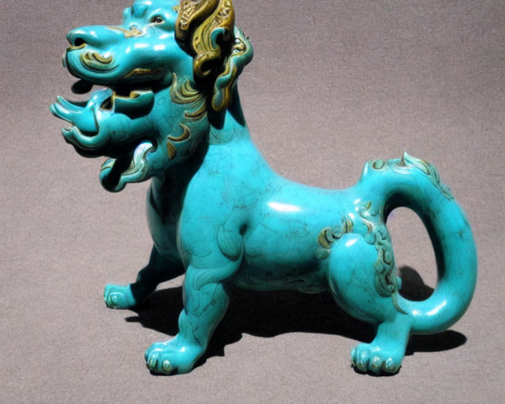 Intricate Turquoise and Gold Chinese Guardian Lion Figurine on Grey Background