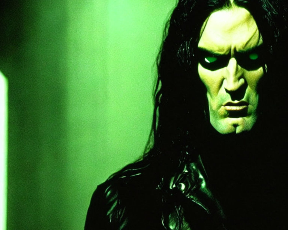 Portrait of Person with Long Dark Hair and Stern Expression in Black Clothing against Green-lit Background