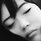 Monochrome close-up of woman's face with closed eyes