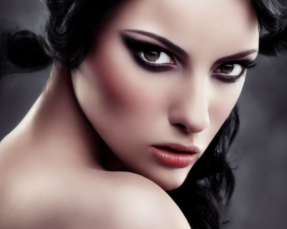 Portrait of woman with dark hair, pale skin, and dramatic eye makeup