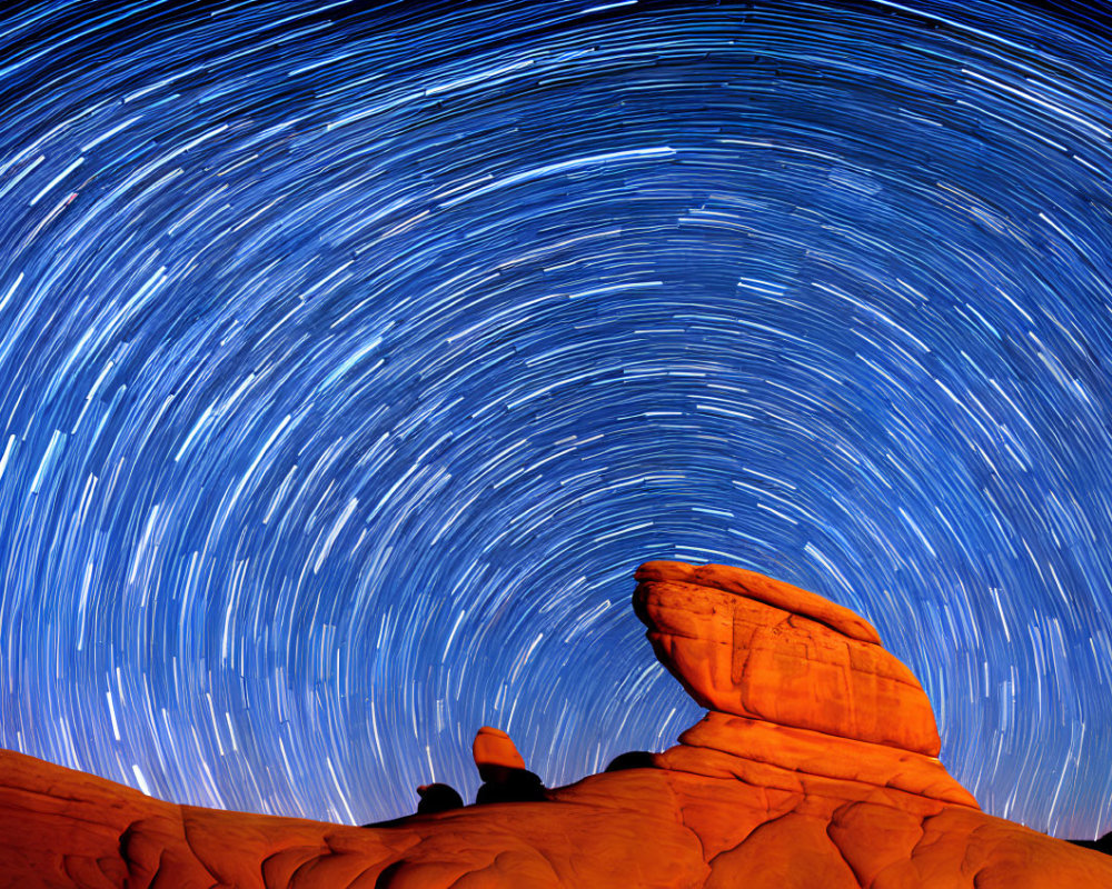 Circular Star Trails Over Orange Rock Formations at Night