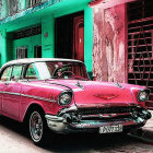 Vintage Red Car Parked Beside Pastel-Colored Building