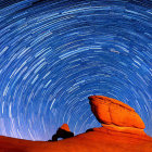 Circular Star Trails Over Orange Rock Formations at Night