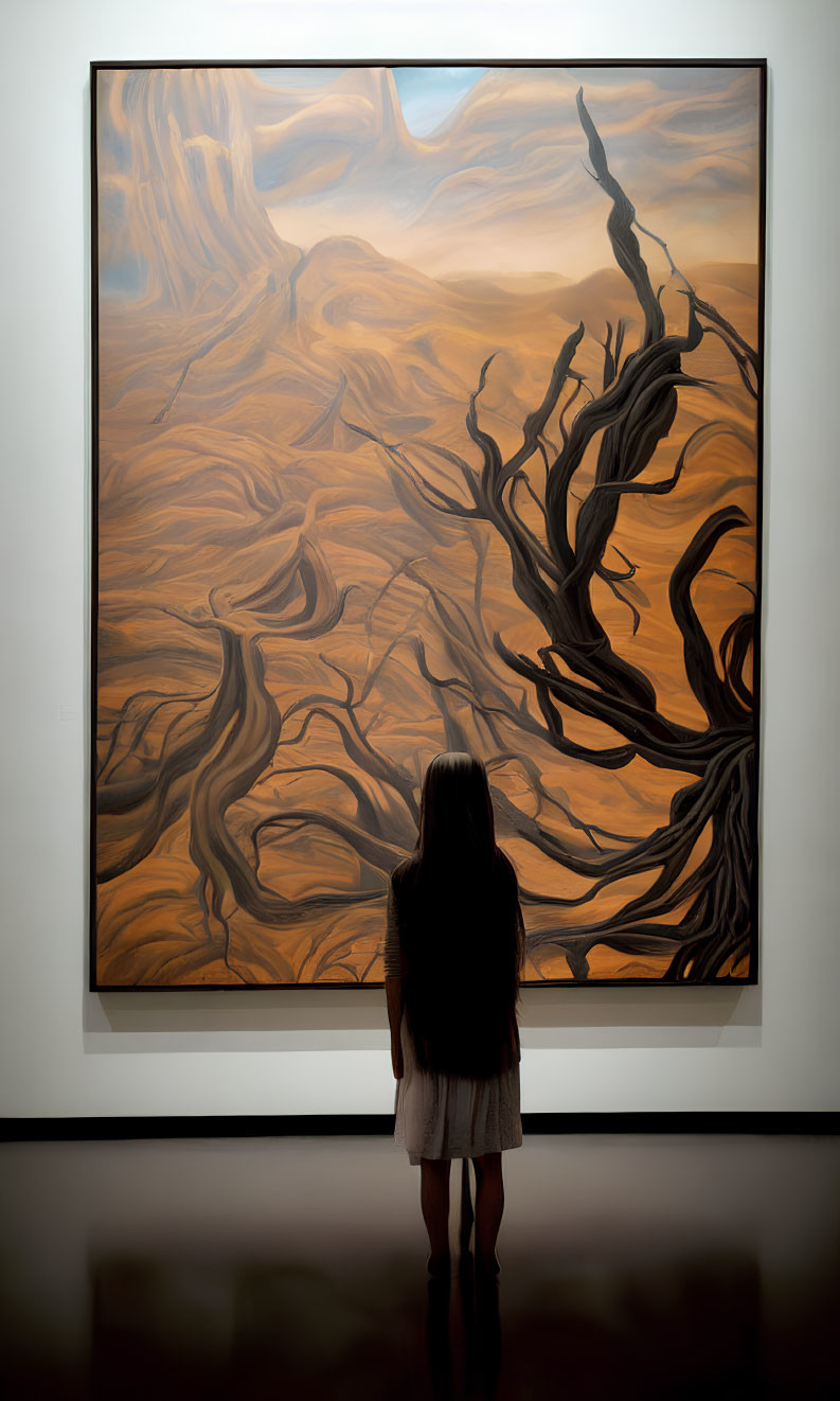 Long-haired person in front of swirling abstract painting with gnarled branches.