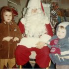 Children posing with Santa Claus in festive setting
