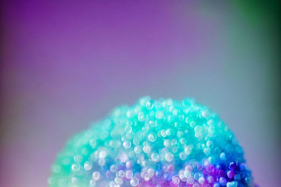 Detailed Close-Up of Purple to Teal Gradient Beaded Object