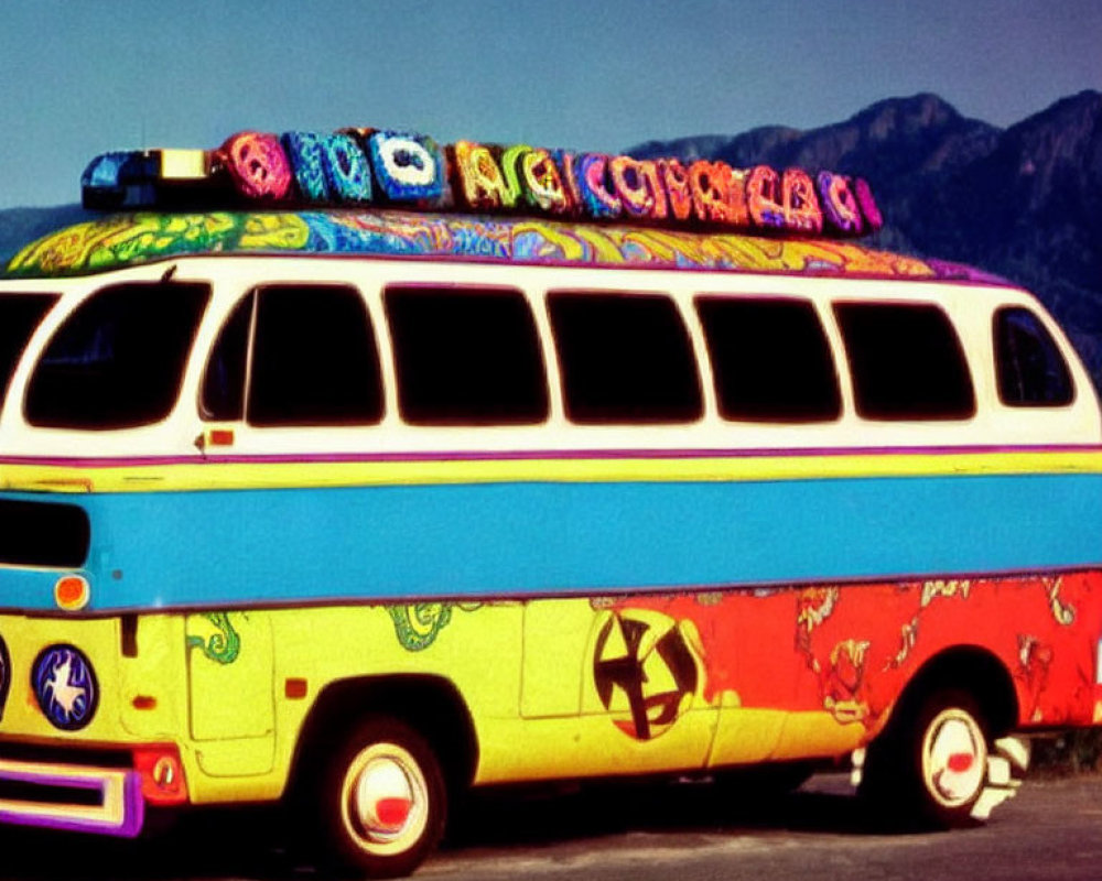 Vintage bus with psychedelic patterns and peace sign, rooftop adorned with woven blanket, set against mountain backdrop