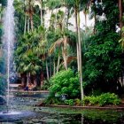 Tranquil garden scene with waterfall, statue, lush greenery, flowers, and pond.